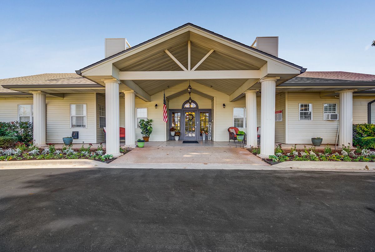 A large building entrance with grand columns and a welcoming porch.