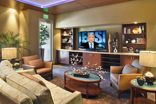 A modern living room with comfortable seating and a large television.