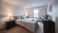 A cozy and well-decorated bedroom with a large bed and window.