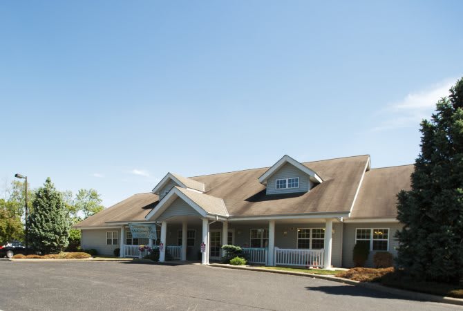 A single-story building with a sloped roof and a welcoming entrance.