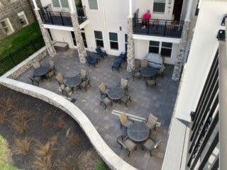 Aerial view of an outdoor patio area with tables and chairs next to a building.