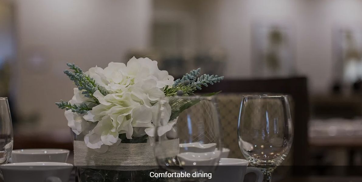 A beautifully set table with elegant floral arrangements and glassware.
