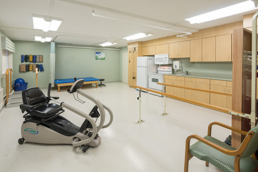 A spacious rehabilitation room featuring exercise equipment and a sterile environment for physical therapy.