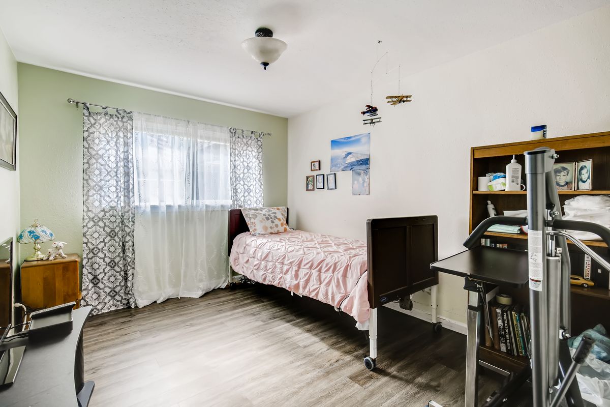 A cozy bedroom with a single bed, desk, and decorative items.