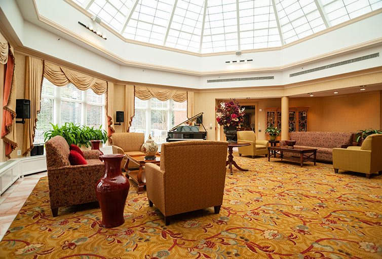 A spacious lobby with comfortable seating and a large dome ceiling allowing natural light to illuminate the room.