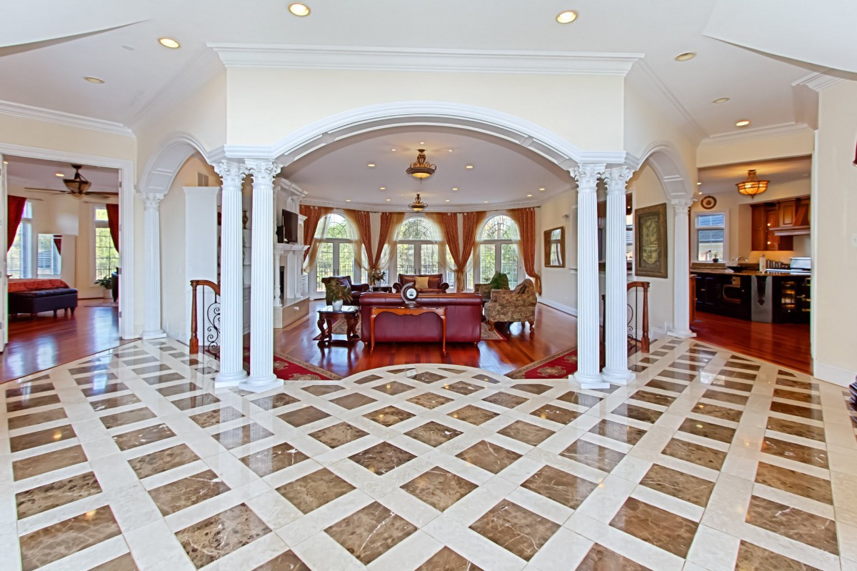 A luxurious living room with arched doorways and elegant furnishings.