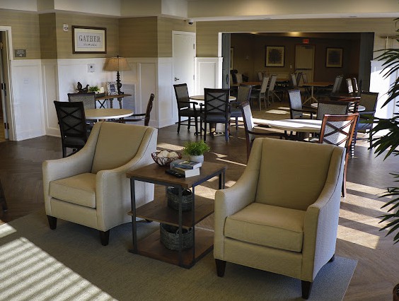 A modern lounge area featuring comfortable beige chairs and stylish decor.