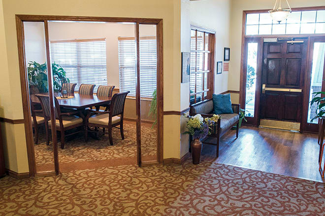 A welcoming office space featuring a meeting room and a lobby area with comfortable seating.