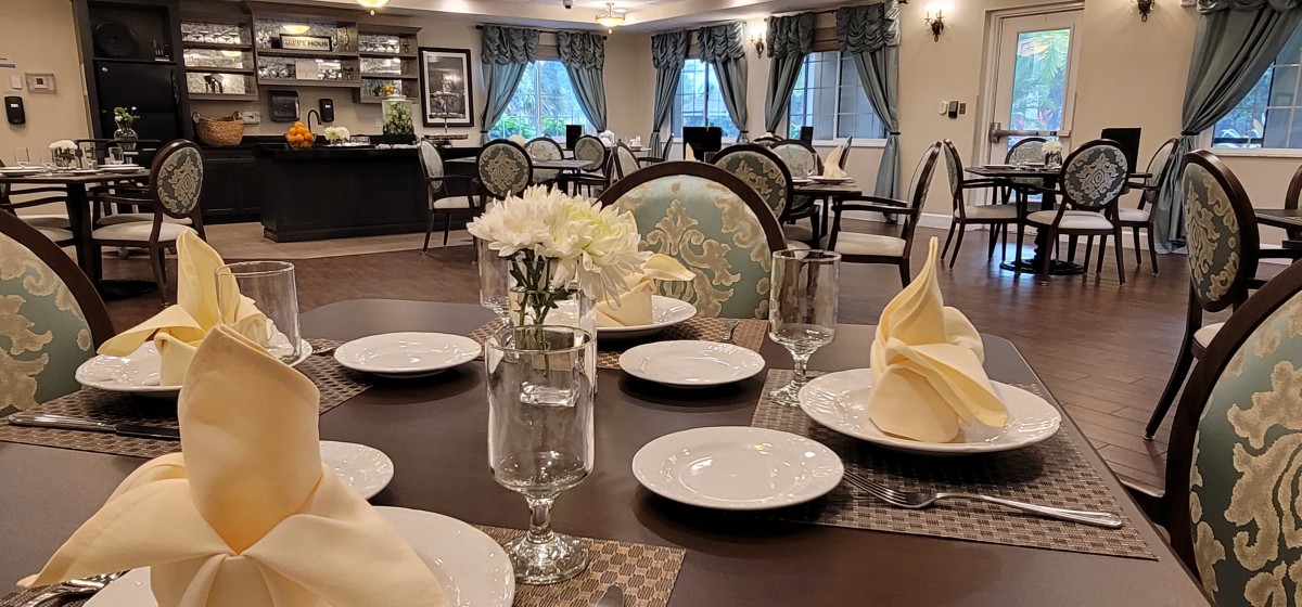 An elegantly set dining table in a well-decorated restaurant environment.
