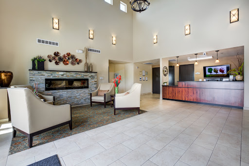 A modern lobby featuring a cozy sitting area with a fireplace and reception desk.