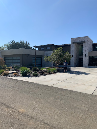 A modern residential home featuring contemporary design and well-maintained landscaping.
