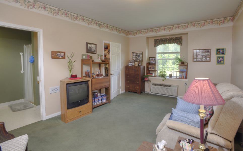 A cozy living room with vintage decor and a large window.