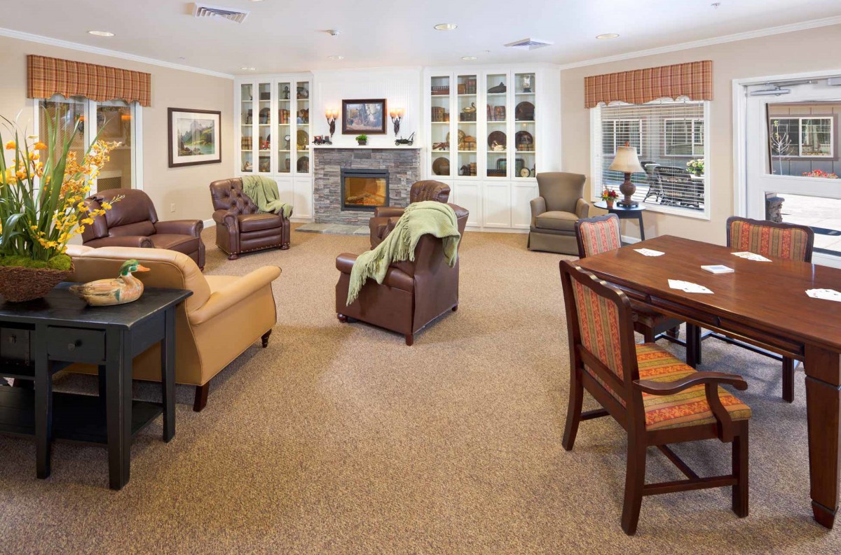 A cozy living room with comfortable seating and a central fireplace.
