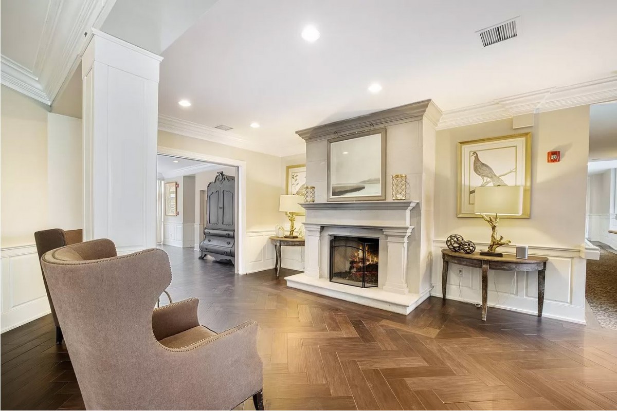 A cozy living room with a fireplace and elegant interior design.