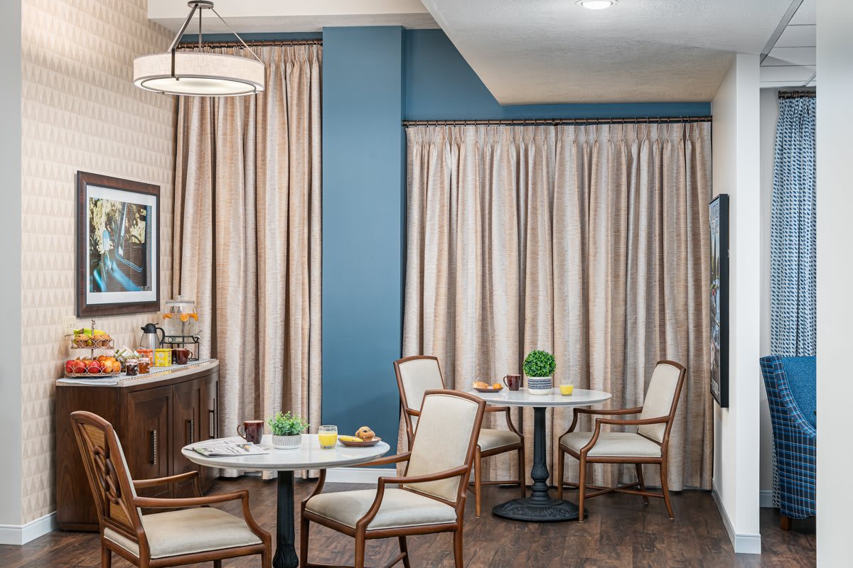 A cozy dining area with elegant curtains and classic wooden furniture.