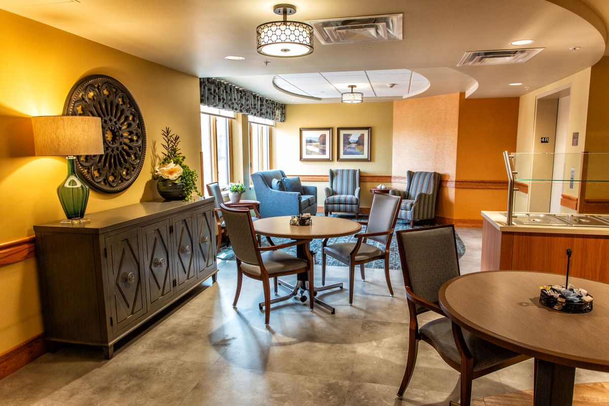 A cozy lounge area with comfortable seating, decorative elements, and warm lighting.