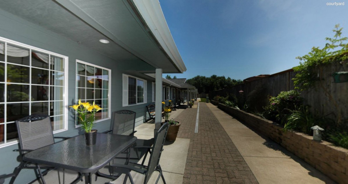 A modern outdoor patio area with seating and a view of the surrounding landscape.