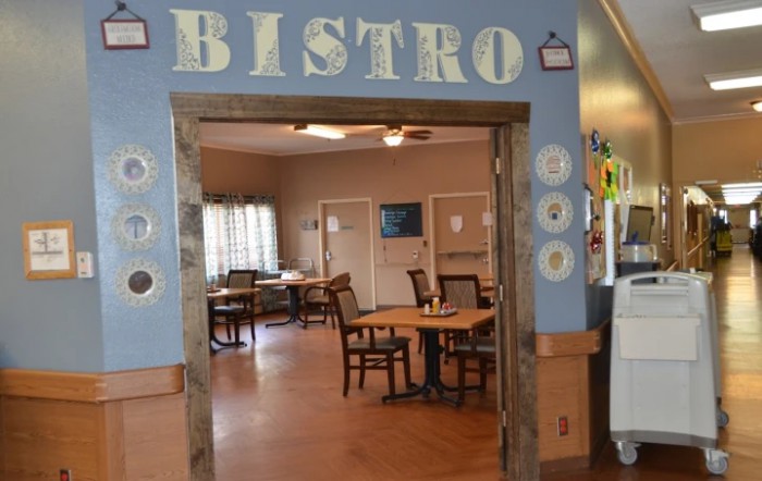A cozy bistro interior with wooden tables and chairs.