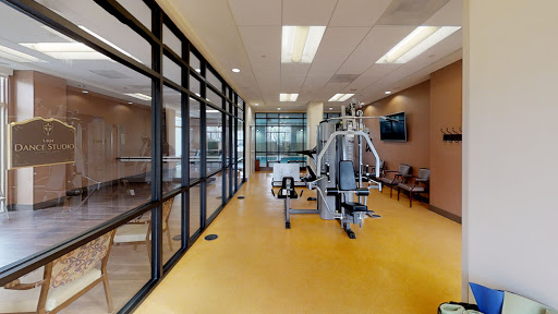 A view of a modern rehabilitation gym featuring various exercise equipment.