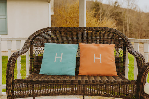 A cozy outdoor setting with colorful cushions on a wicker bench.