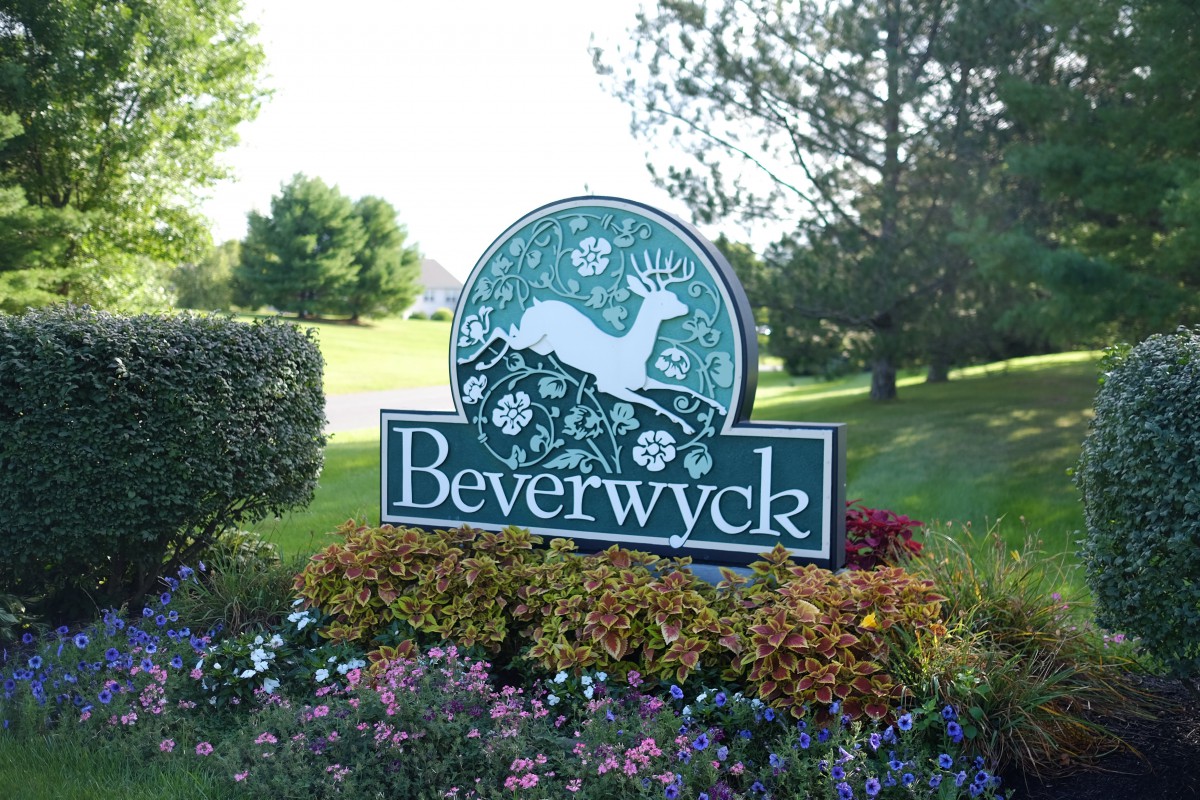 A decorative sign for Beverwyck surrounded by flowers and greenery.