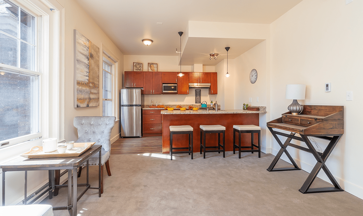 A modern open-plan kitchen and living area with stylish decor and contemporary appliances.