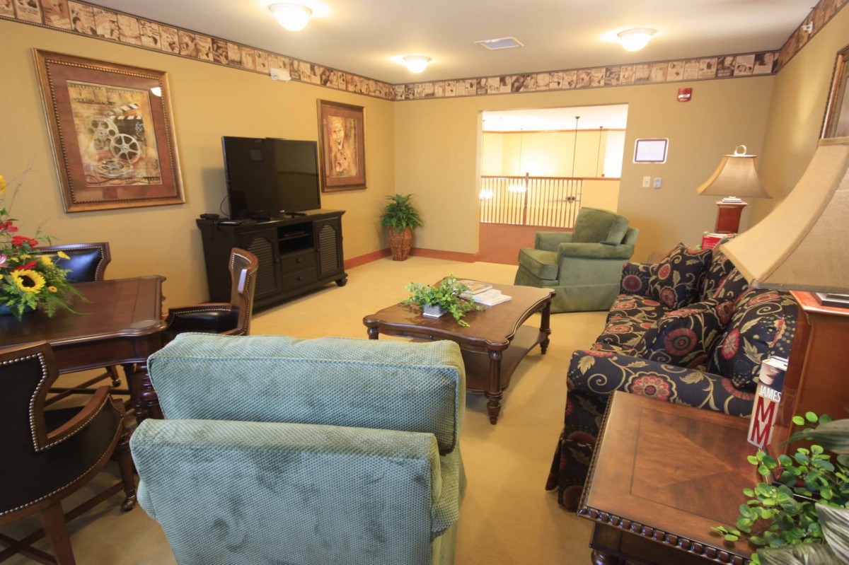 A cozy living room with comfortable seating and a large TV.