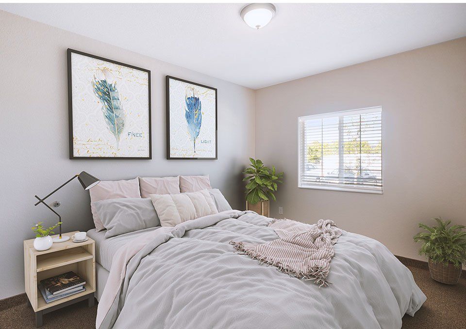 A cozy, minimalist bedroom with simple decor and natural light.