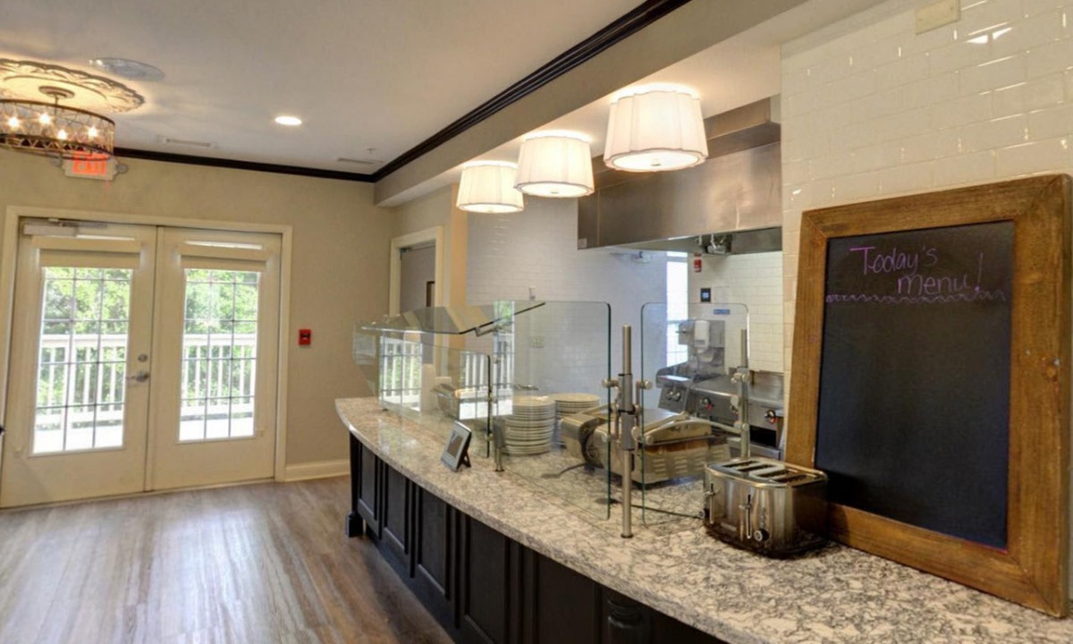 A modern kitchen with sleek countertops and elegant lighting fixtures.