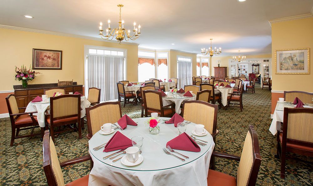 An elegantly arranged dining room with neatly set tables and comfortable chairs.