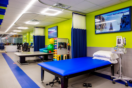 A vibrant physical therapy room equipped with exercise tools and treatment areas, designed to promote healing and rehabilitation.