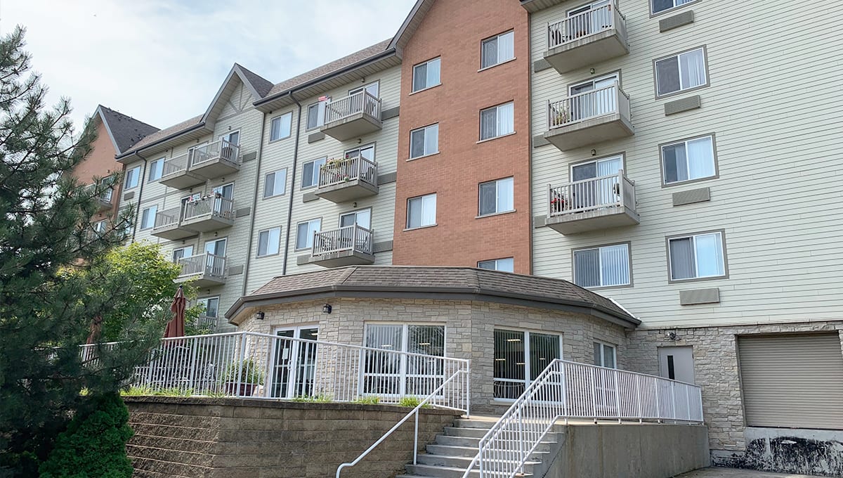 A multi-story residential building with balconies and large windows.