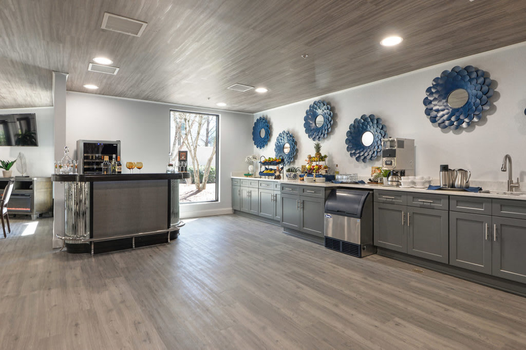 A modern kitchen with blue decor accents and a catering setup.