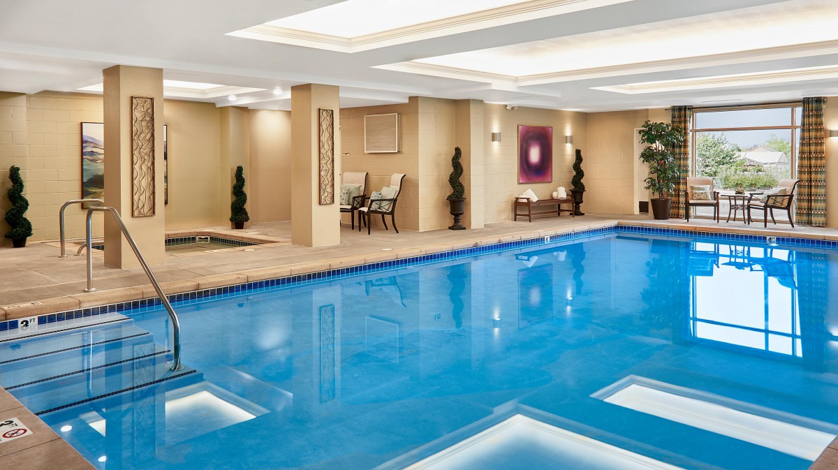 Luxurious indoor swimming pool with elegant decor and ambient lighting.