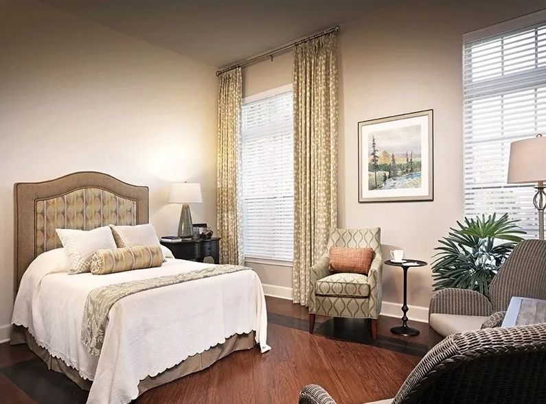 A cozy and well-decorated bedroom with elegant furniture and natural lighting.