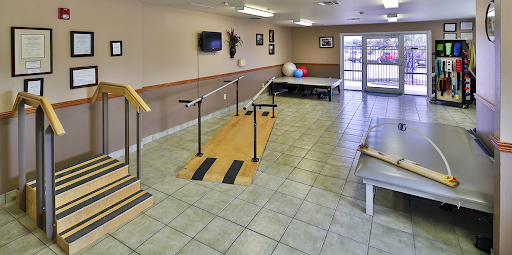 A physical therapy room equipped with walking aids and exercise equipment, designed for rehabilitation.