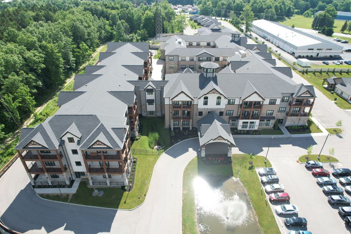 Aerial view of a modern apartment complex surrounded by greenery.