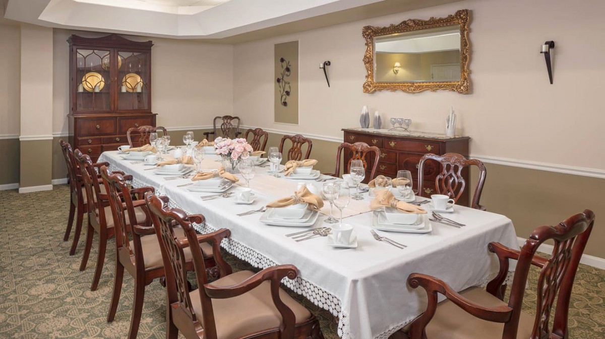 A beautifully set dining table in an elegant room, ready for a formal gathering.