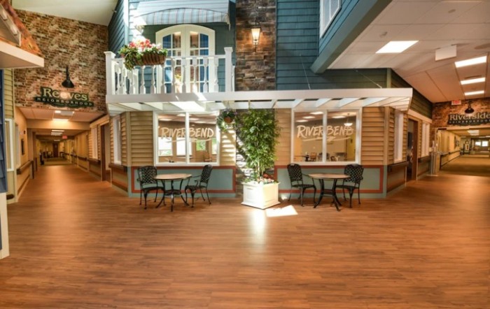 An inviting indoor cafe with cozy seating and a touch of greenery.