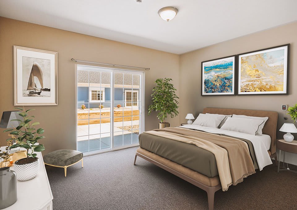 A modern bedroom with stylish decor, featuring a comfy bed, framed artwork, and a large window.