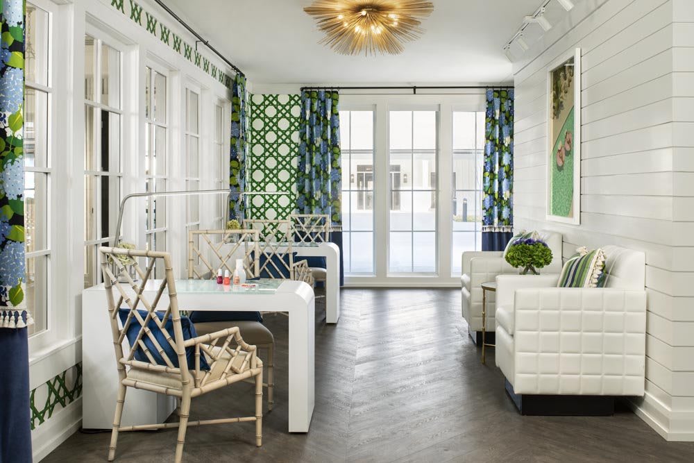 A stylish and modern dining area featuring geometric patterned curtains, contemporary furniture, and bright lighting.