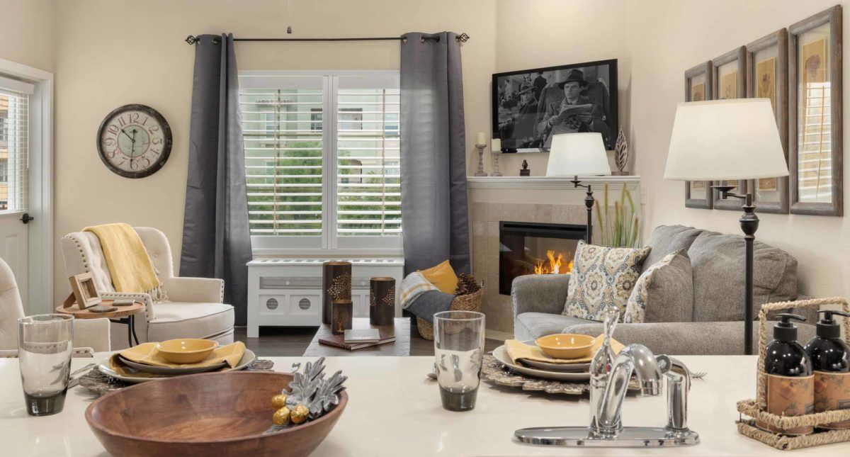 A cozy living room with a fireplace, comfortable seating, and decorative elements.