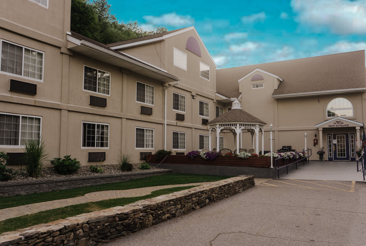 Exterior view of a residential building with a landscaped entrance.