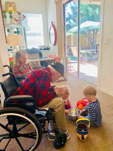 A heartwarming moment of interaction between a grandparent and young children, showing the beauty of family connections.