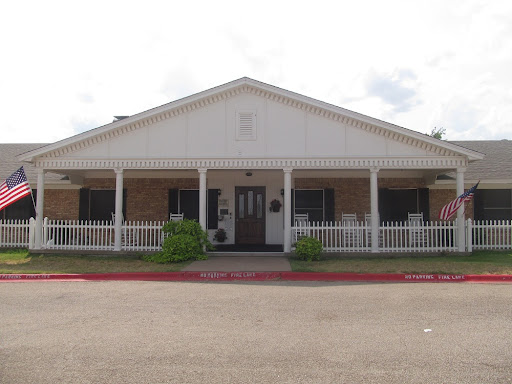 A welcoming residential building featuring a front porch and garden.
