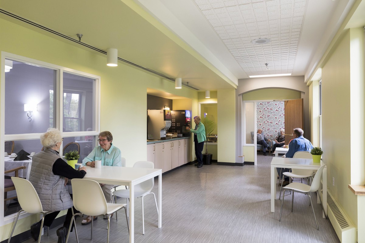 A modern cafeteria where people are enjoying their meals at tables.