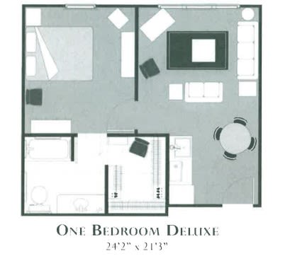 Floor plan of a One Bedroom Deluxe apartment highlighting furniture arrangement and room dimensions.