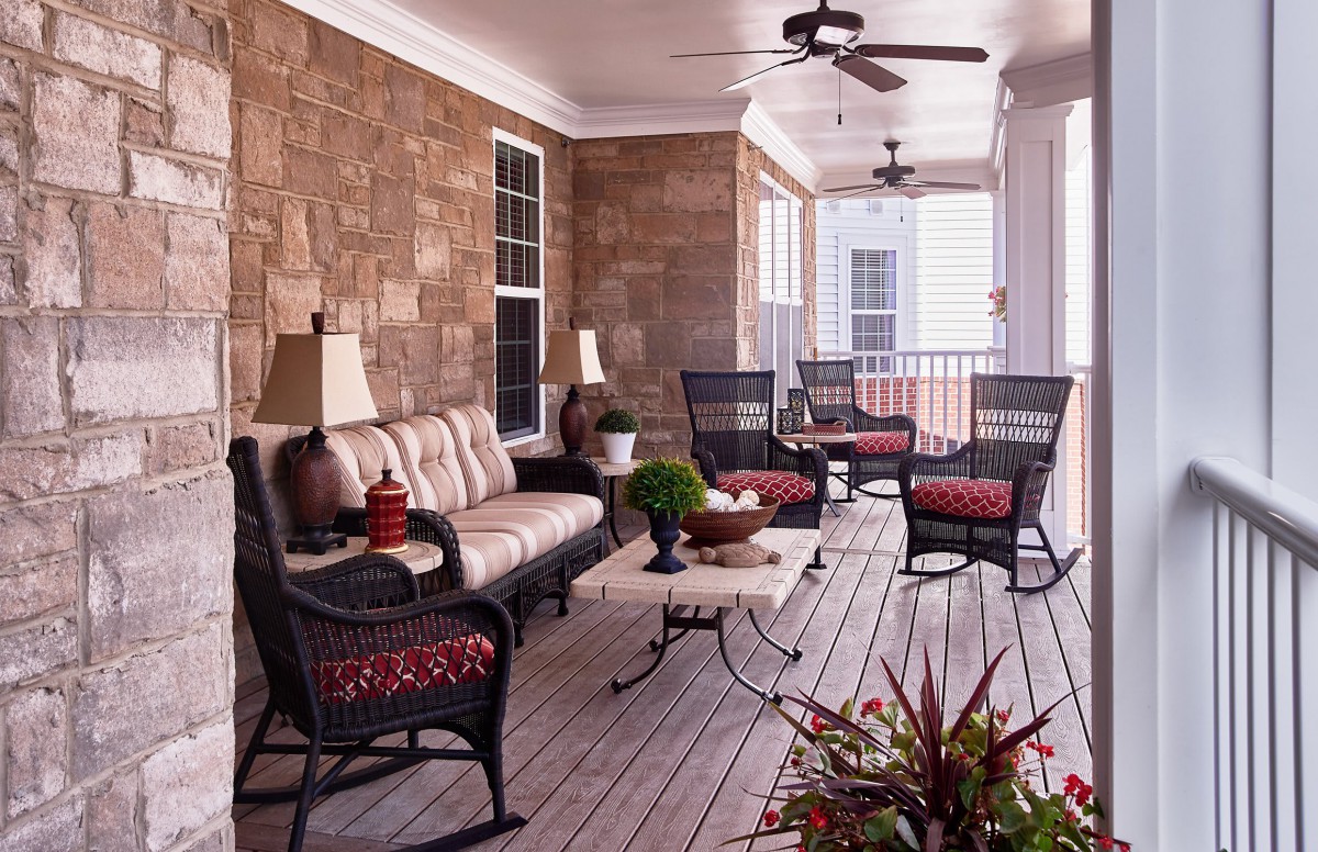 A cozy patio with wicker furniture and stylish decor.