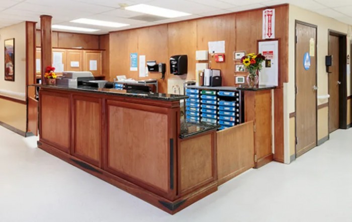 A neatly organized reception area with wooden paneling and office supplies.