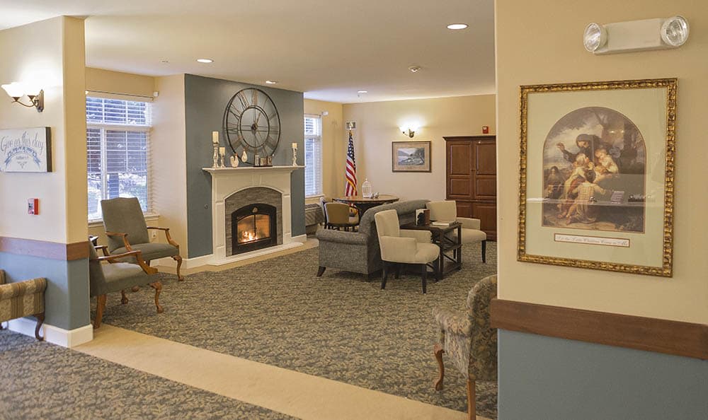 A cozy living room with a fireplace and seating area.